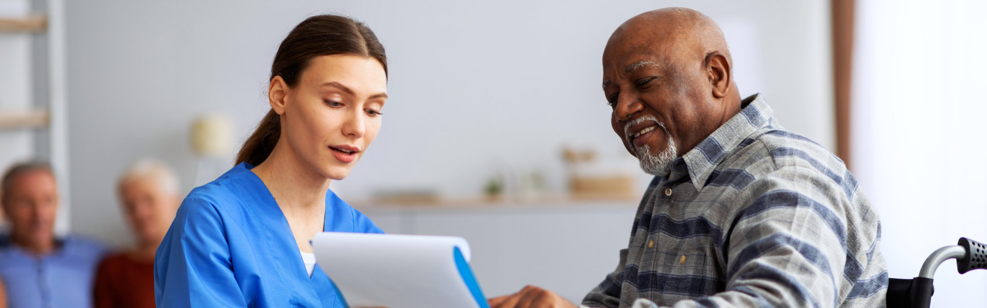 caregiver and elderly man talking